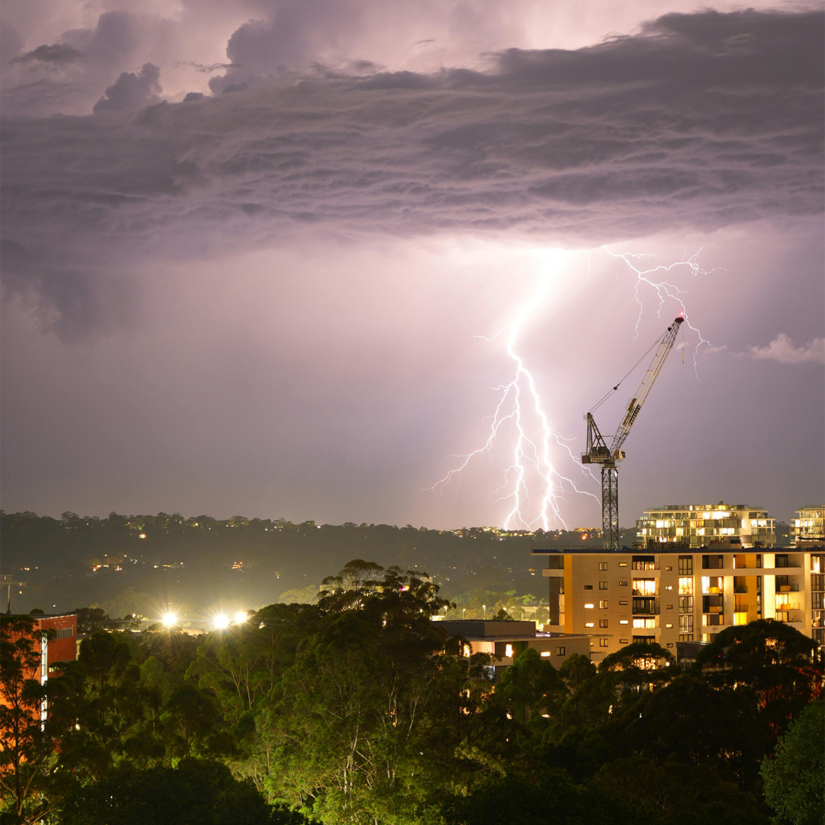 Dramatic night lightning over urban skyline
