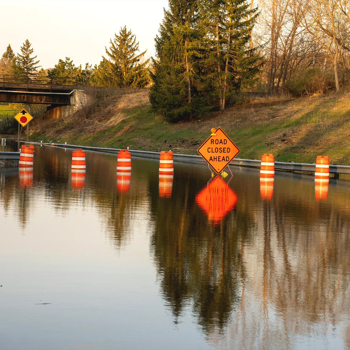 Flooded road and a warning sign