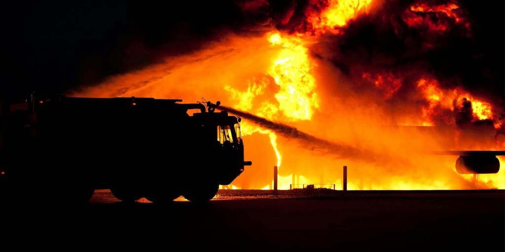 Firetruck spraying water on fire